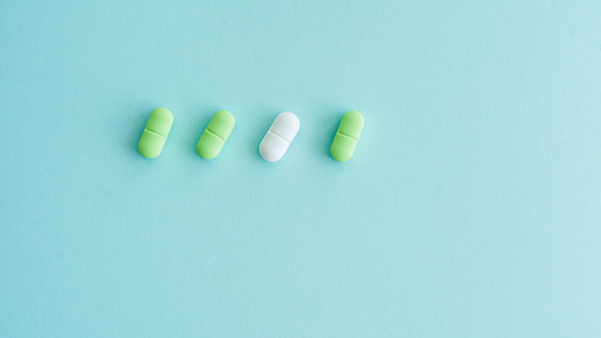 Modafinil Generic Price Comparison: Finding the Best Value Minimalist image of green and white pills on light blue surface — modafinil generic price comparison