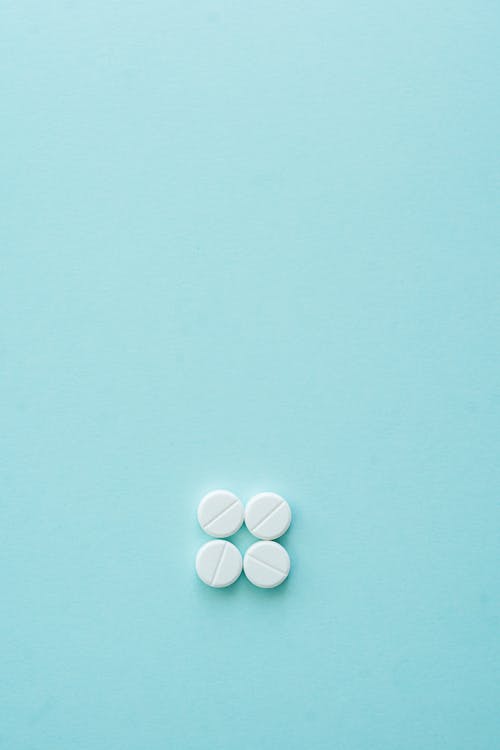 White Tablets on Blue Surface