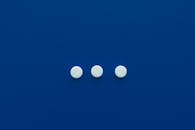 Round Pills on Blue Background