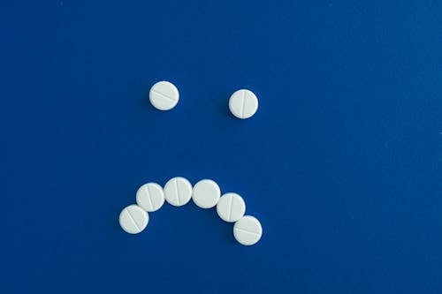 Free Medicine Tablets on Blue Surface Stock Photo