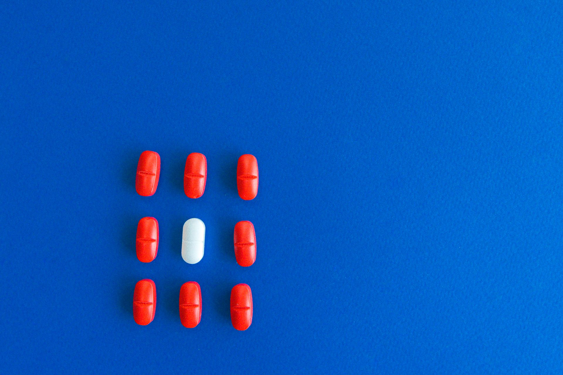 Medication Tablets on Blue Textile