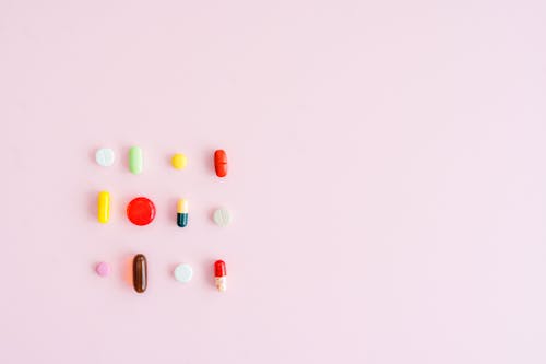 Capsules and Pills on Pink Background