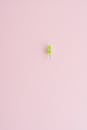 A Single Push Pin on Pink Surface