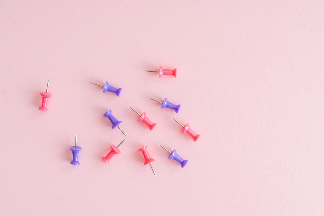 Pinimg Background Pins against a Pink Background · Free Stock Photo