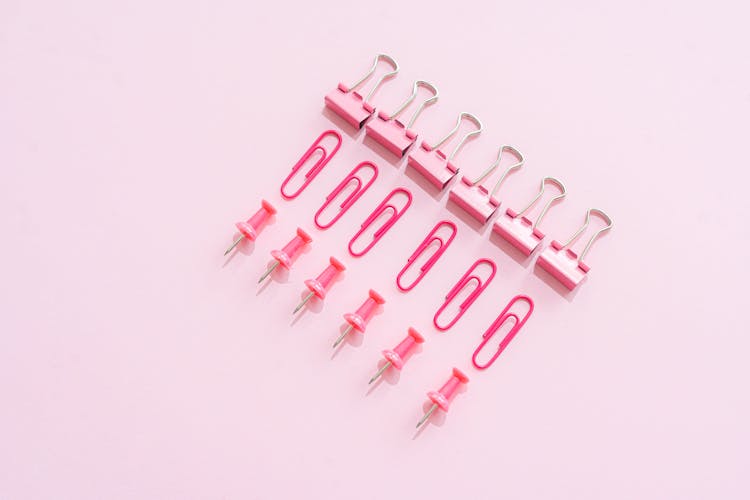 Clips And Pins On A Pink Surface