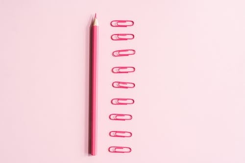 Pink Pencil Near Paper Clips