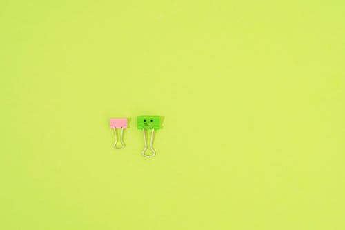 Binder Paperclips on a Green Background 