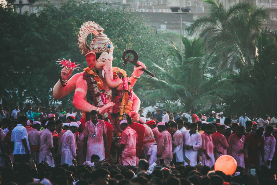 Colorful crowds celebrate Ganesh Chaturthi in Mumbai with a grand Ganesha statue.