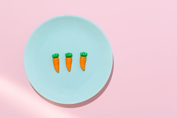 Artificial Carrots On Blue Plate