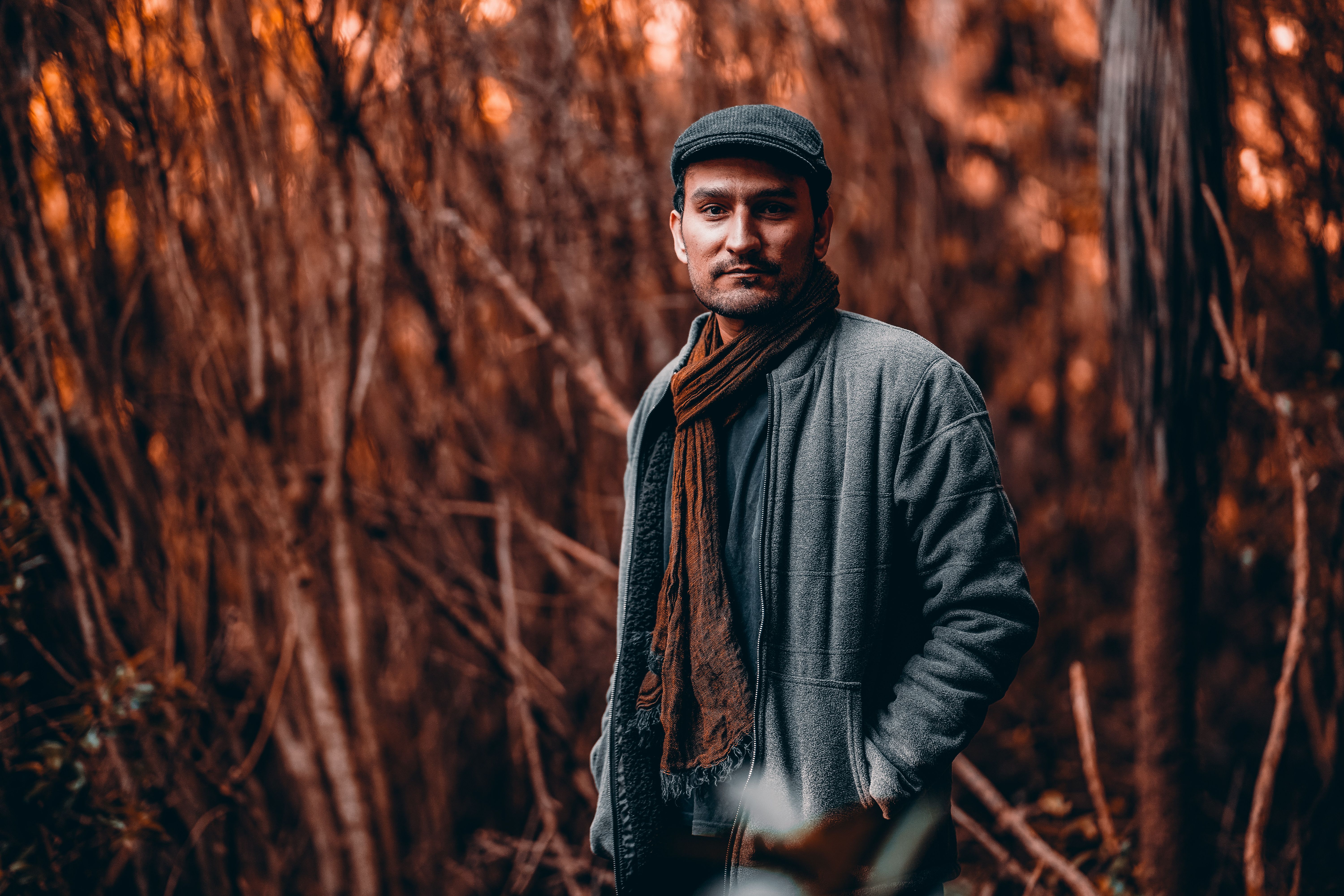 Portrait of a Man Standing in a Forest · Free Stock Photo