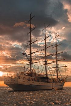 A stunning sailboat captured at sea with an enchanting sunset sky, perfect for travel and adventure themes.
