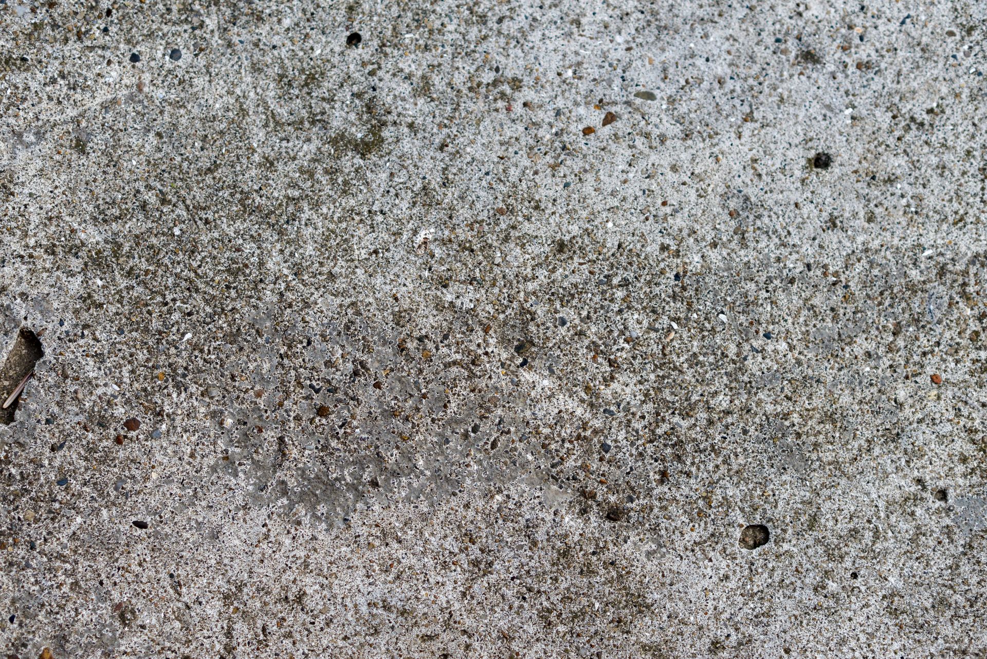 Detailed close-up of an eroded, textured concrete surface showing intricate patterns and wear.