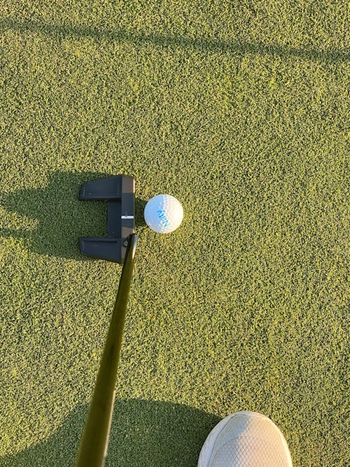 A White Golf Ball on Green Grass Field