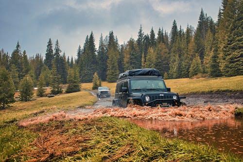A Black Jeep on a Muddy Field