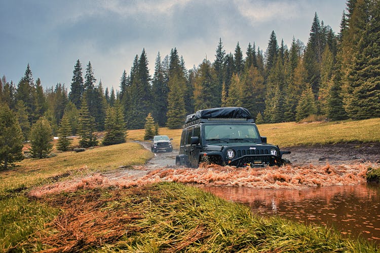 A Black Jeep On A Muddy Field