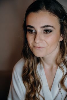 Close-up portrait of a smiling woman with long hair and subtle makeup.