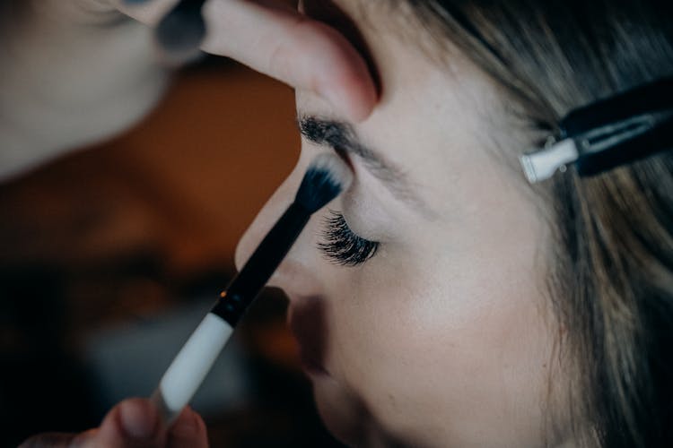 Close Up Of A Woman Applying Makeup