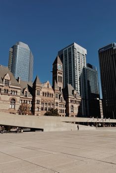 Scenic view of Toronto's blend of historic and modern architecture under clear blue skies.