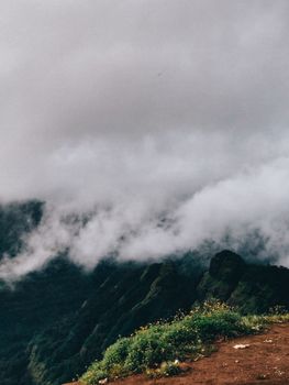 Stunning mountain landscape enveloped in clouds, showcasing nature's raw beauty and tranquility.