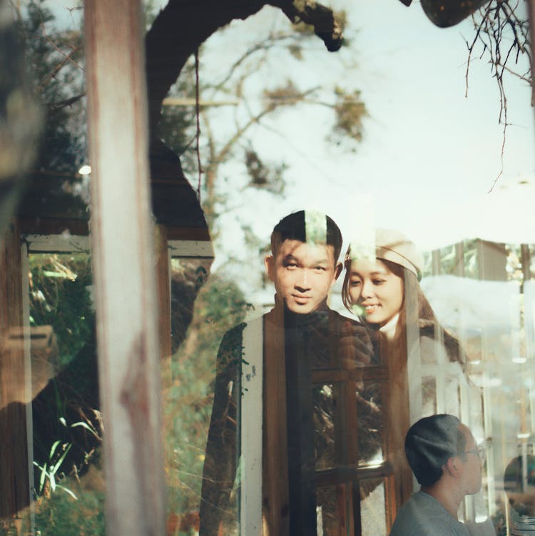 Couple's Reflection On A Glass 