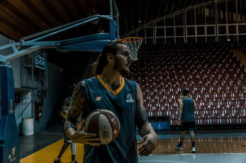 Man in Blue and Yellow Basketball Jersey Top