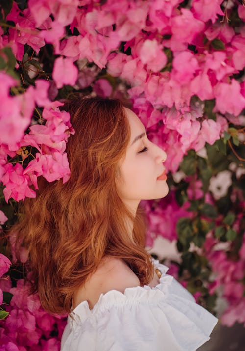 
A Woman beside Pink Flowers