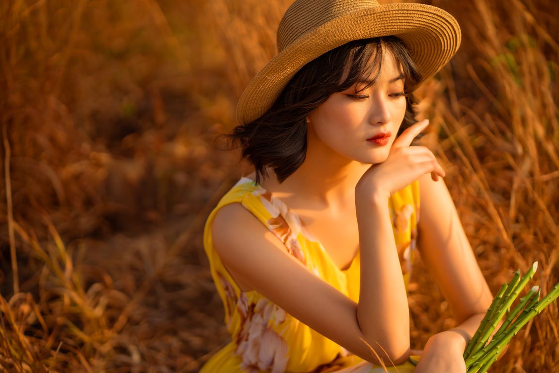 A Pretty Woman in Yellow Top Wearing Straw Hat · Free Stock Photo