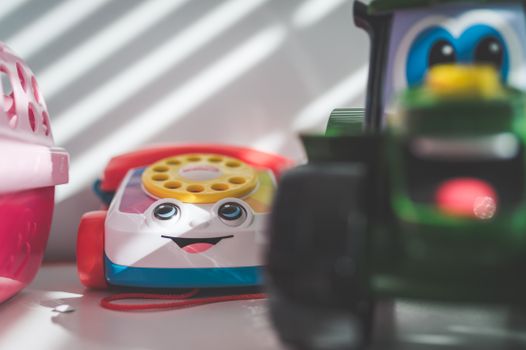 Vibrant close-up of a plastic toy telephone with selective focus on a sunny day.