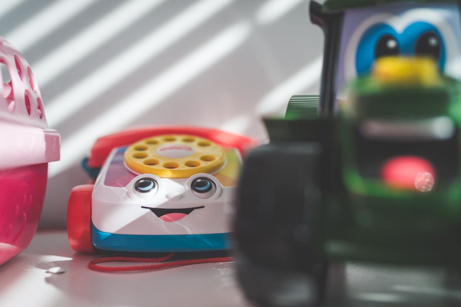 Vibrant close-up of a plastic toy telephone with selective focus on a sunny day.