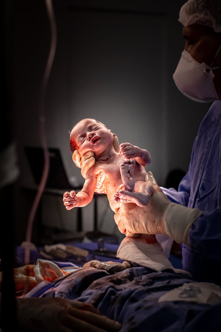 Doctor Holding Newborn Baby