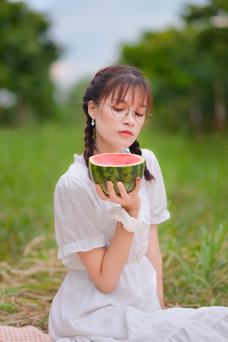 A Pretty Woman Holding A Watermelon