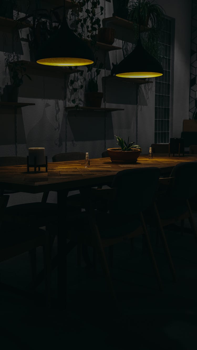 Hanging Lights Over Wooden Table 