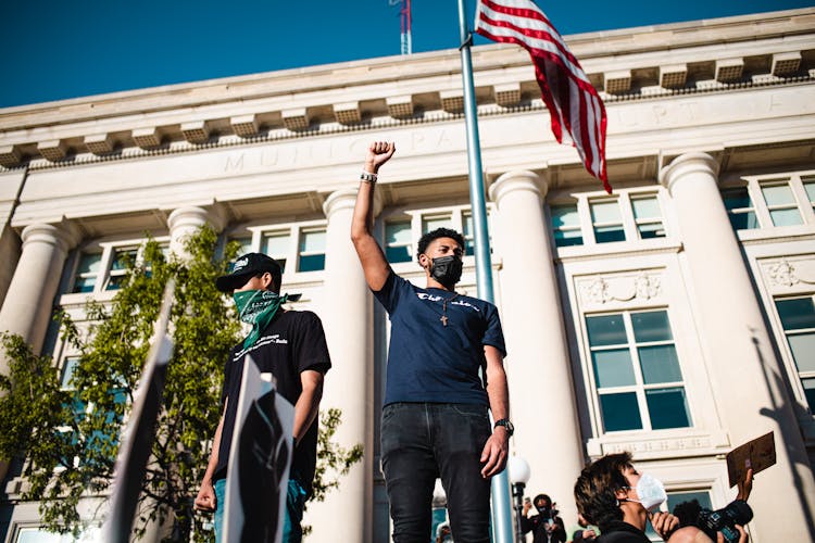 Low Angle Shot Of A Protester With A Clenched Fist 