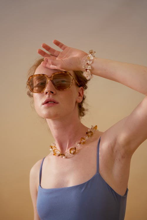 A Woman in Sleeveless and Sunglasses