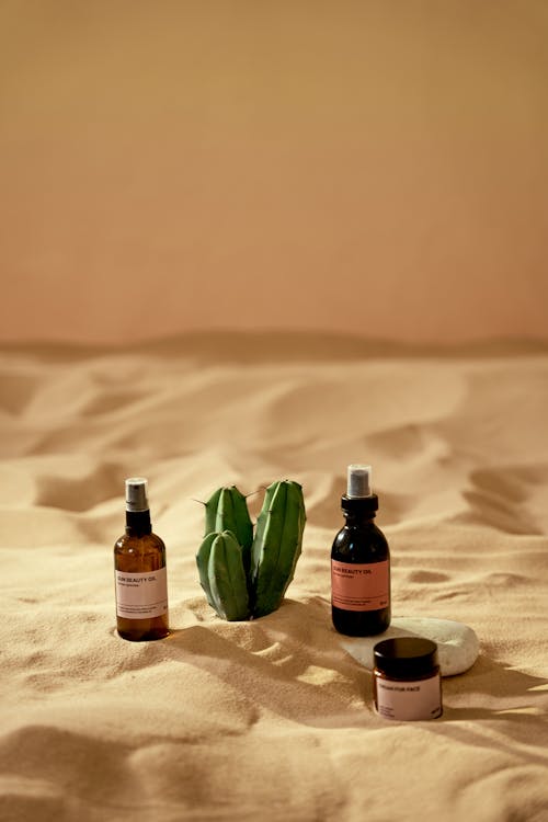 Free Cosmetic Products on a Beach Sand  Stock Photo