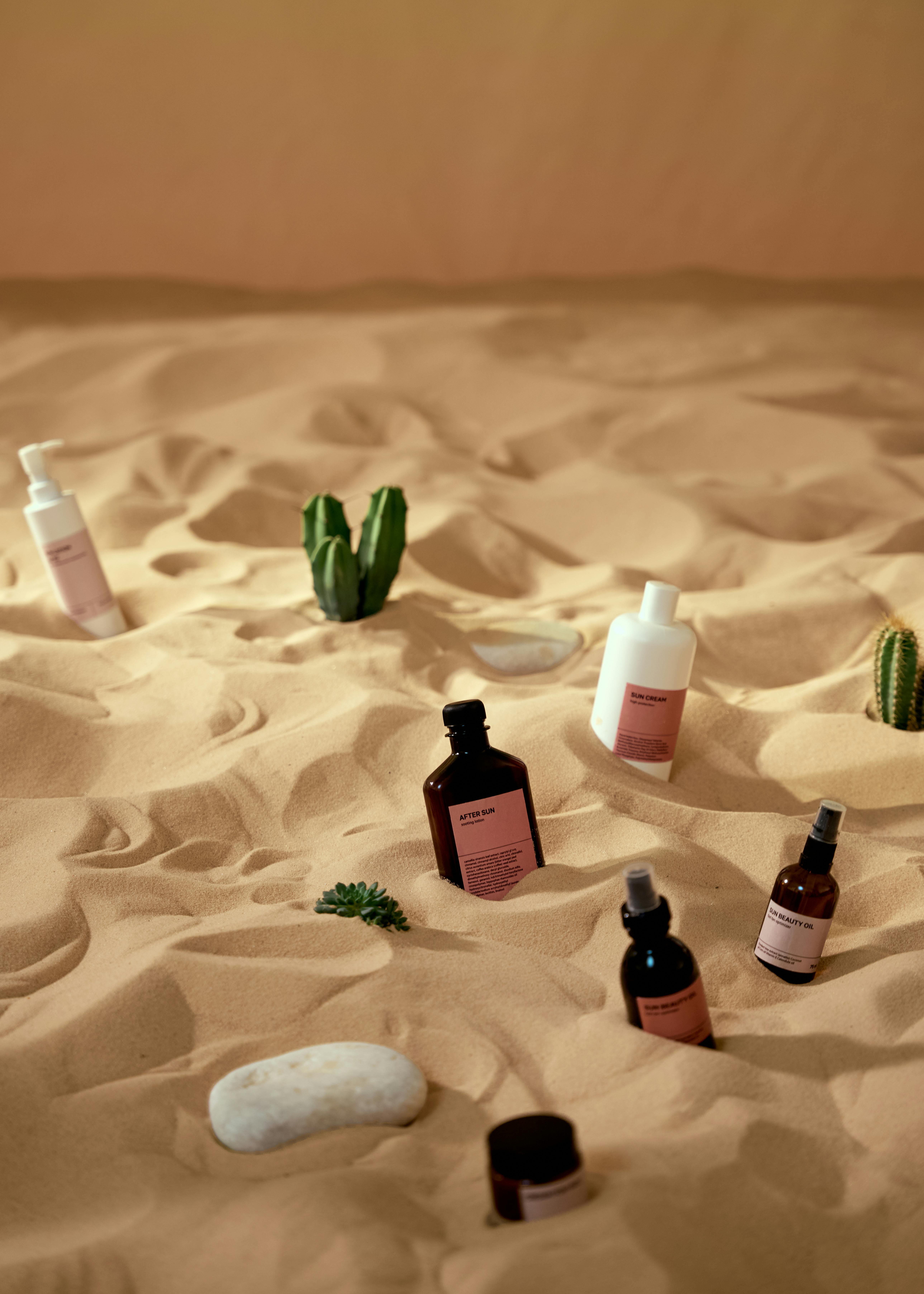 cosmetic products on a beach sand