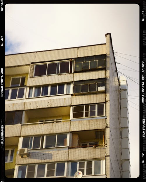 Concrete Apartment Building with Glass Windows and Balconies