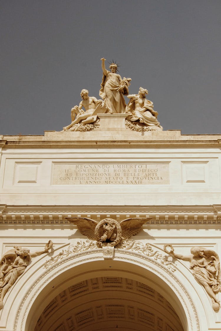 Group Of Statues On Top Of Historical Triumph Arch