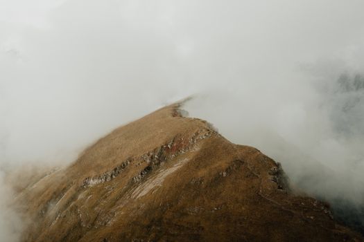 Aerial view of mist-covered mountain peaks in Krasnaya Polyana, Russia, creating a serene landscape.
