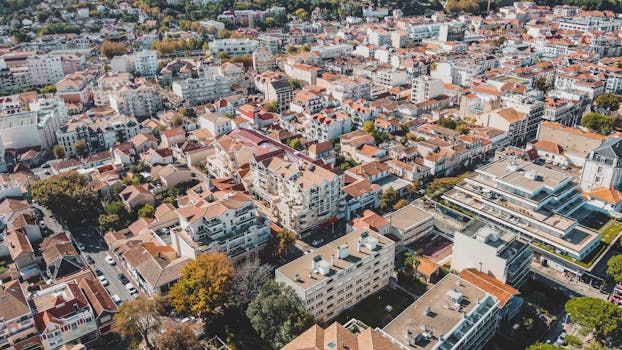 Aerial cityscape of Arcachon, France showcasing urban rooftops and buildings on a sunny day.