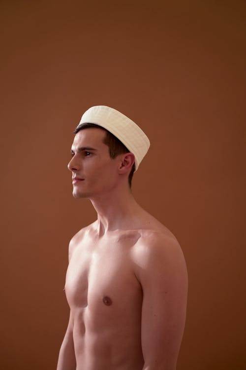 A Handsome Shirtless Man Wearing a Hat