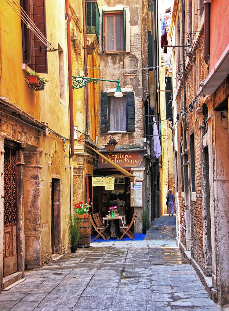 Italian Alley Between Buildings And A Pizzeria 