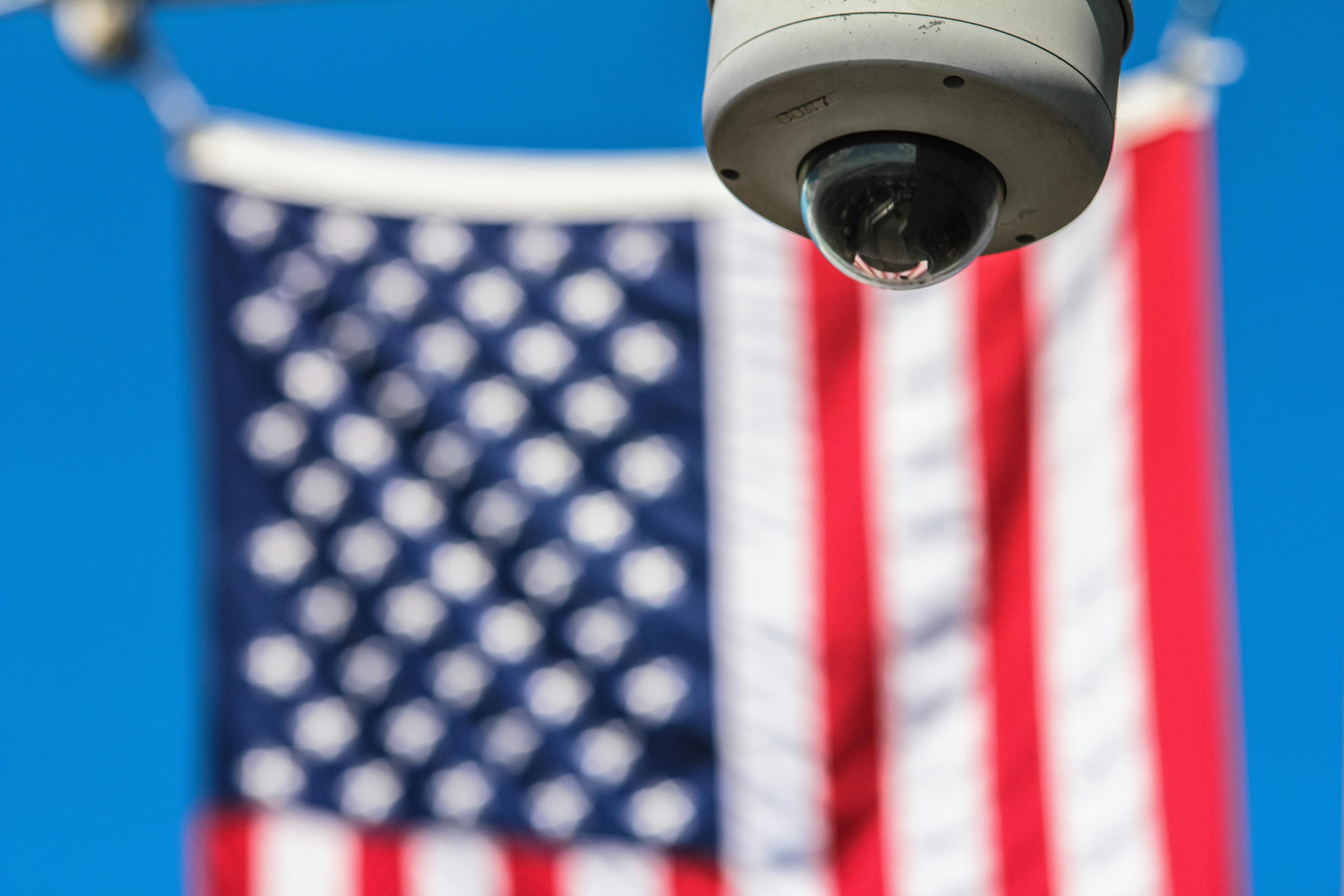 A CCTV camera and a US flag