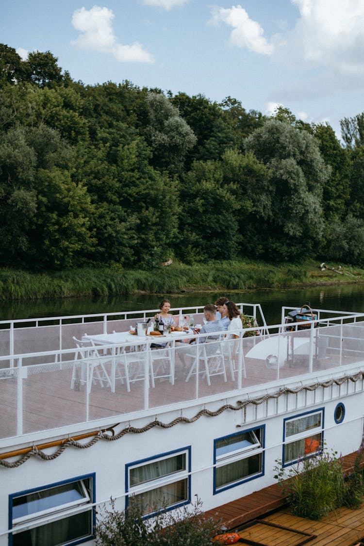 A People Having A Dinner Party In The Yacht