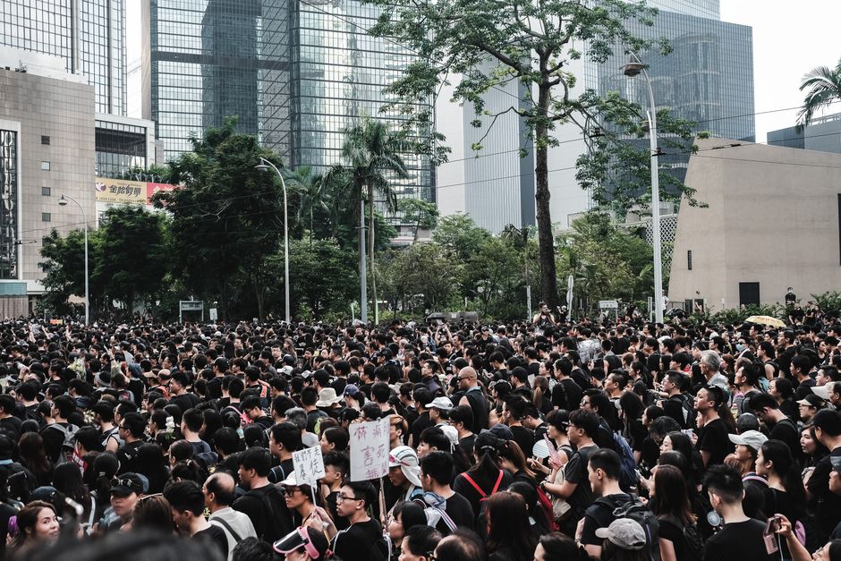 Massive crowd gathers during a protest in Hong Kong's urban district, showcasing urban activism.