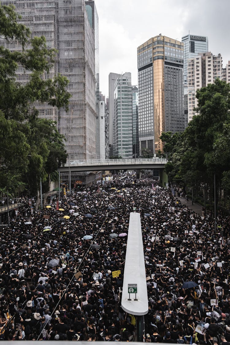 Crowd Of People Protesting And Walking On Street