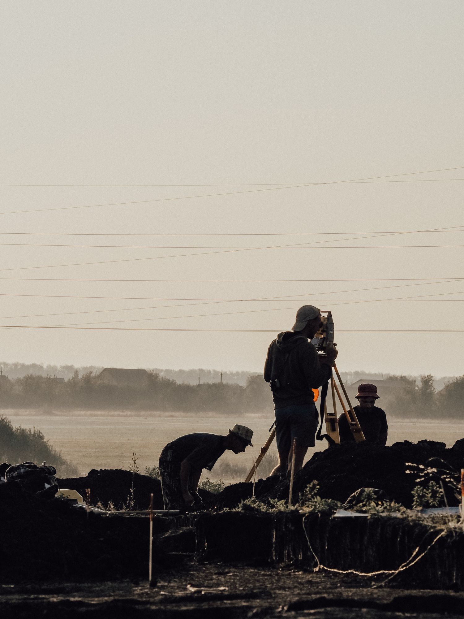 Surveyors operating equipment at a construction site