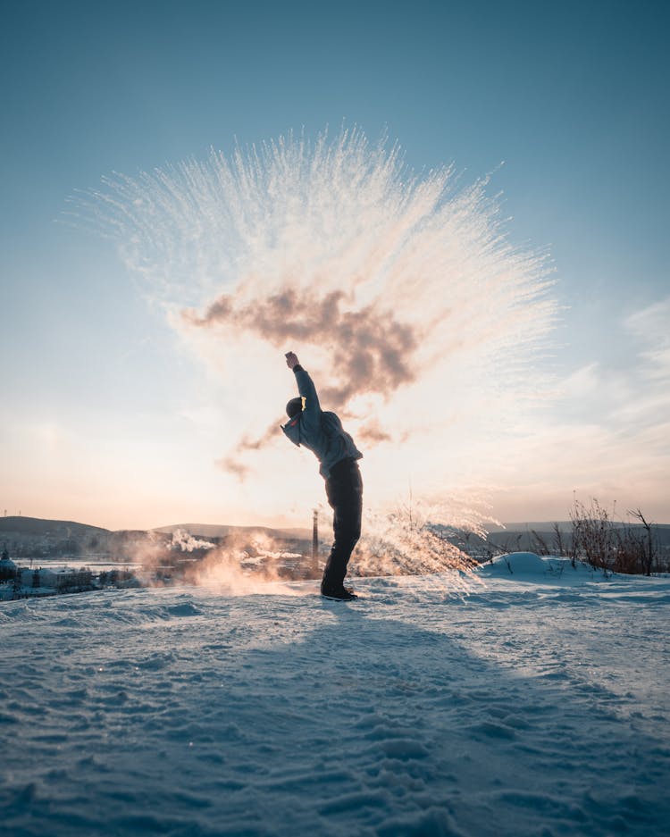 Man Throwing Snow In Winter