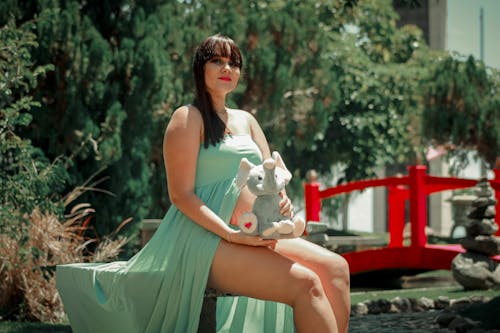 Free Pregnant Woman Holding a Stuffed Toy Stock Photo