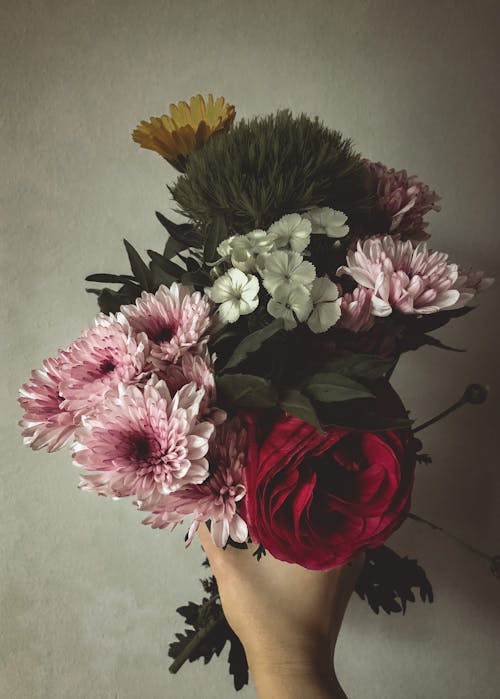 Free Close-Up Shot of a Person Holding a Bouquet of Flowers Stock Photo